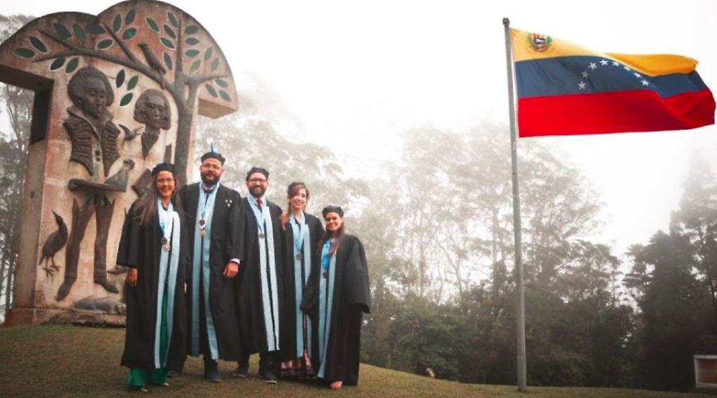 Christopher (centro) durante su acto de grado en el IVIC